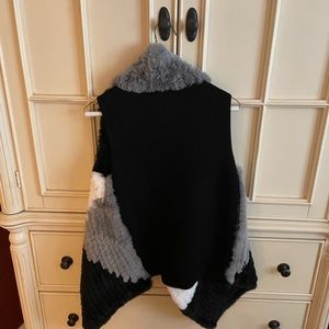 Never worn with tags. Furry black and white vest. Back is sweater material